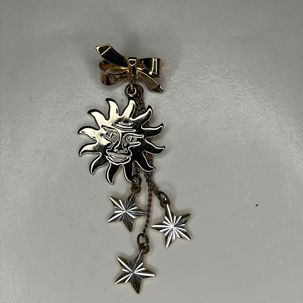 Sun and stars two-tone gold and silver lapel pin brooch.